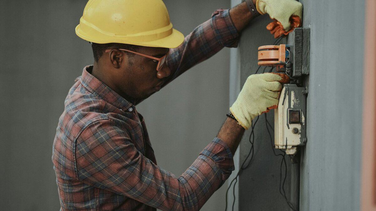 A technician verifying an electrical meter box